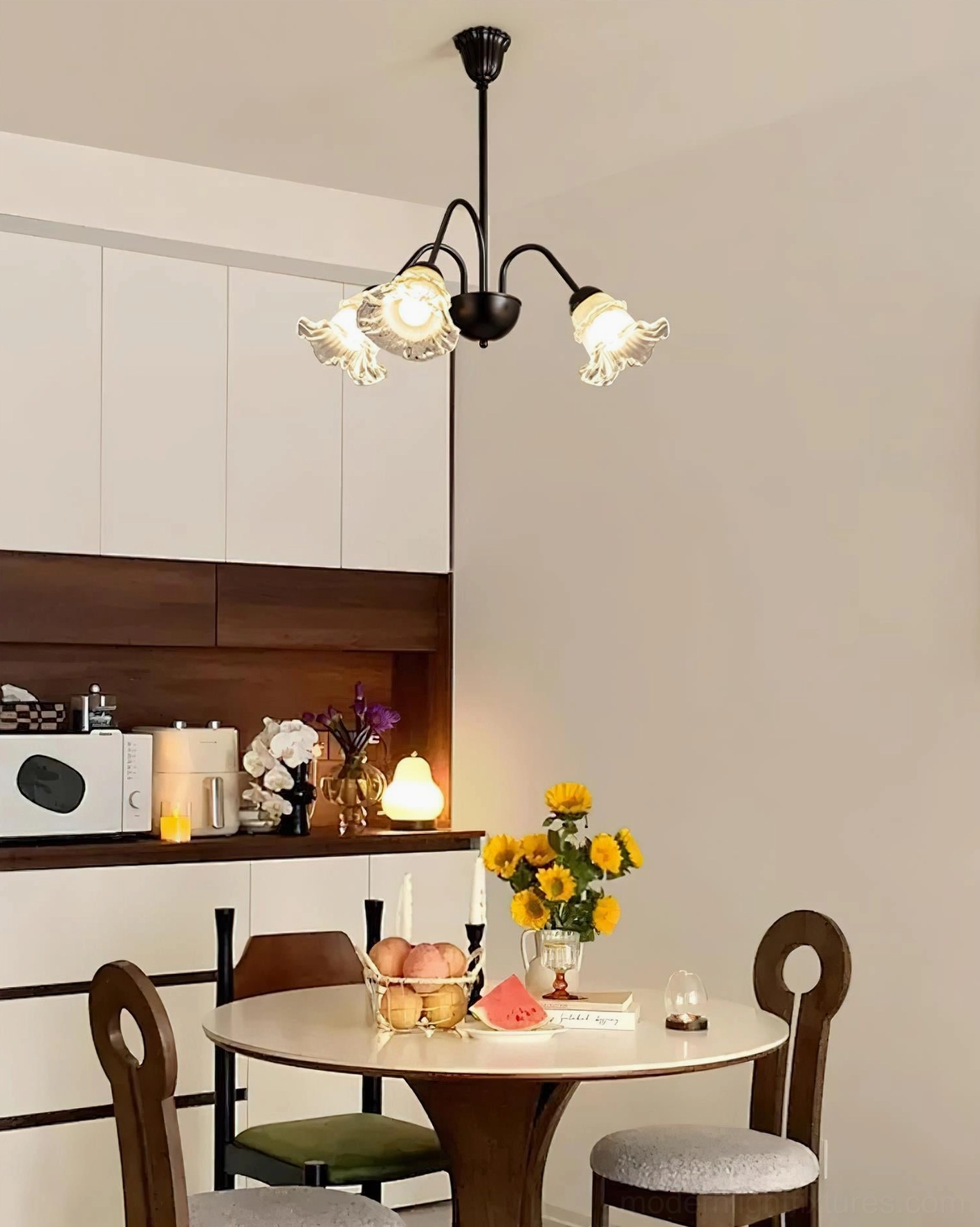 Modern botanical glass chandelier with black metal arms and petal-shaped shade details