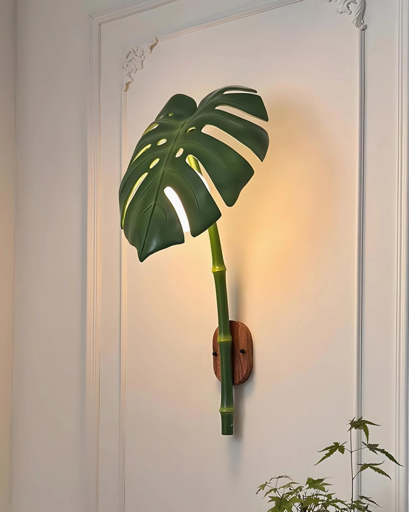 Modern botanical wall light with resin body and metal hardware for entryway or hallway accent