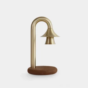 Modern brass candle warmer lamp with dark wood base on white background, front view showing elegant arched stem and bell-shaped shade
