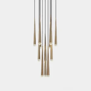 Modern brass cluster chandelier with suspended tapered rod elements on white background