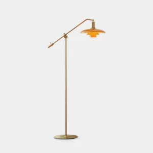 Modern brass floor lamp with adjustable swing arm and orange-amber shade - front studio view