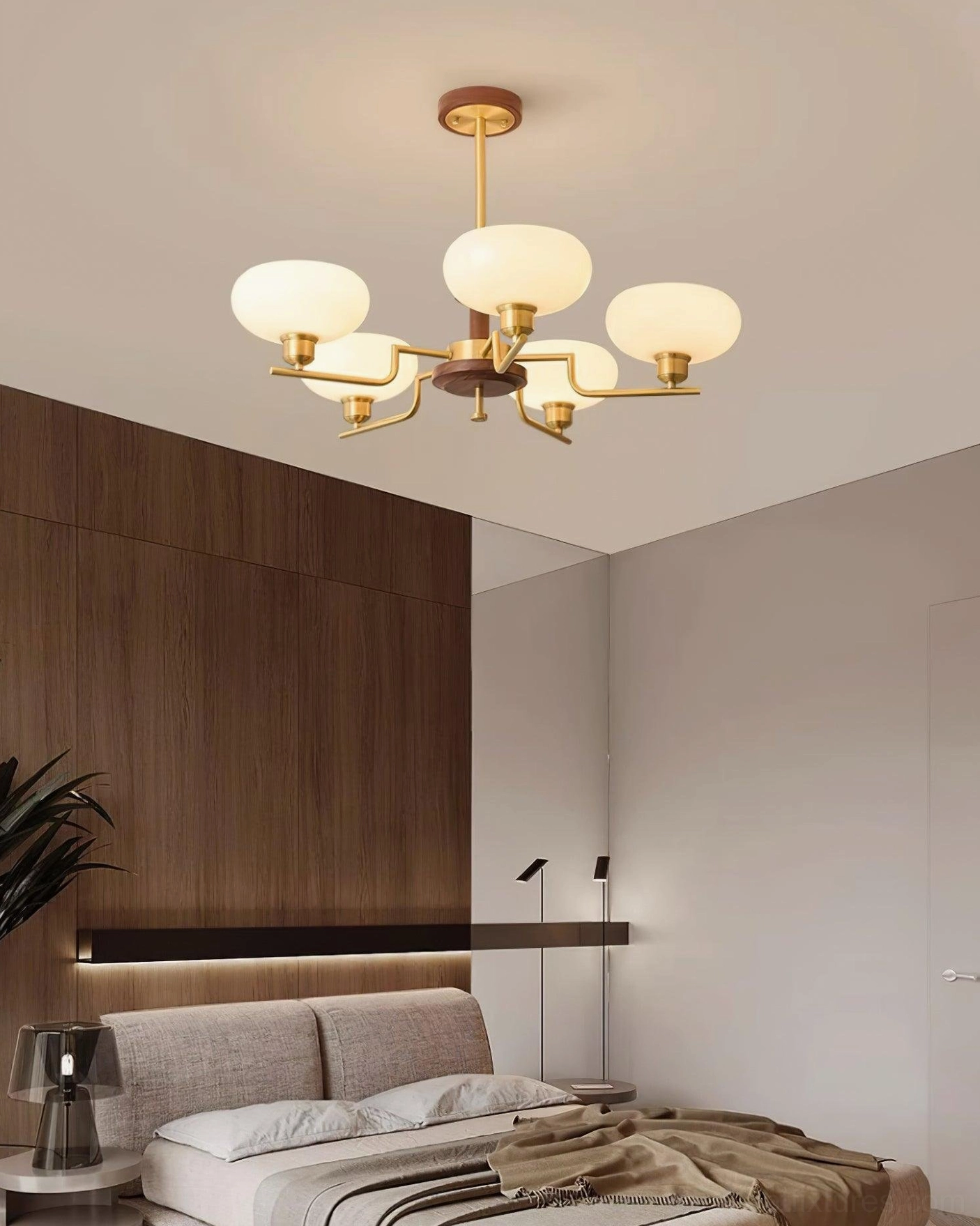 Modern brass and glass pendant chandelier detail shot showing frosted glass shades and metal framework craftsmanship
