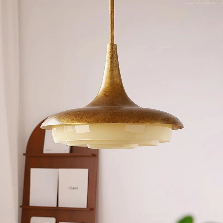 Modern brass pendant light with cream glass dome, detailed view of aged finish and glass layering