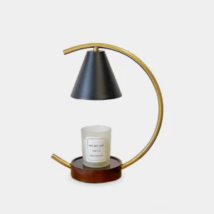 Modern halogen candle warmer lamp with polished gold arc frame, matte black conical shade, and dark wood base on white background