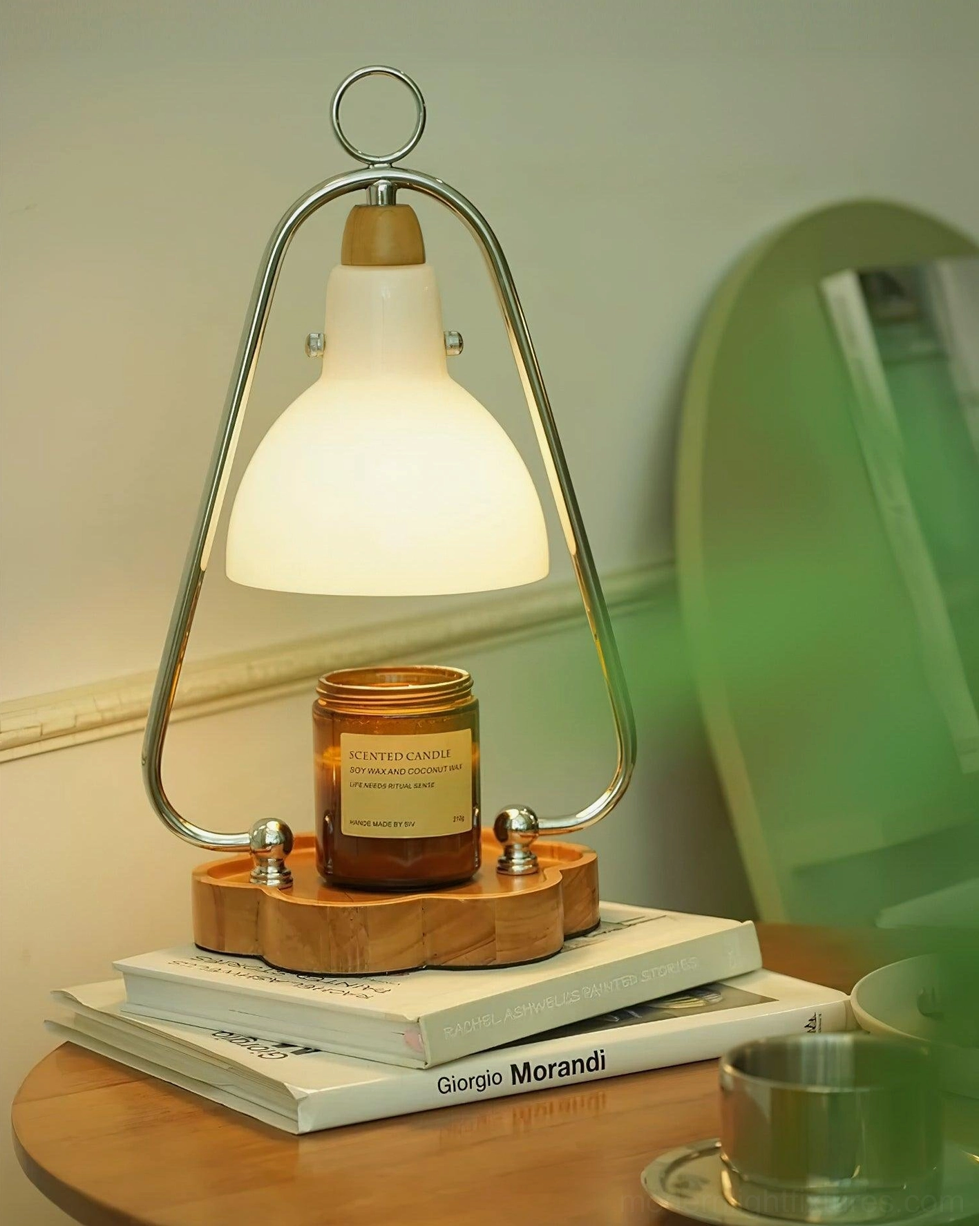 Elegant candle warmer lamp positioned on decorative table with Giorgio Morandi books aesthetic