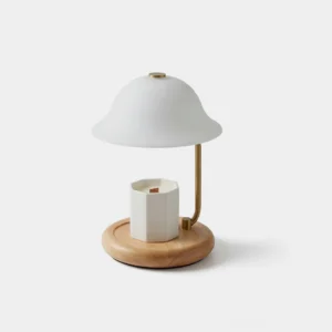 Modern candle warmer table lamp with white mushroom shade, curved metal stem, and natural wood base on neutral background