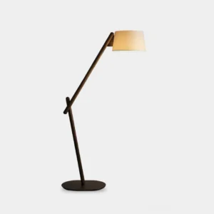 Modern cantilever floor lamp with minimalist dark metal frame and beige fabric shade on white studio background