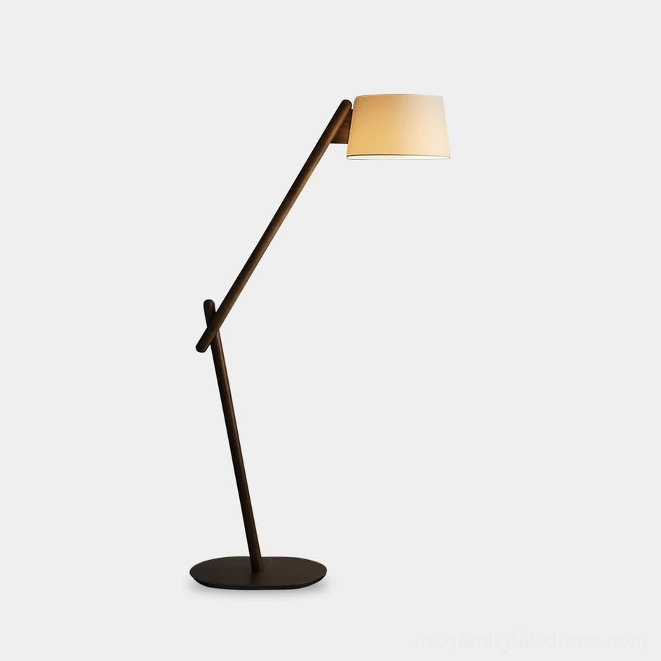 Modern cantilever floor lamp with minimalist dark metal frame and beige fabric shade on white studio background