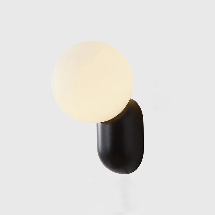 Modern cantilever wall sconce design detail showing resin construction and glass shade integration