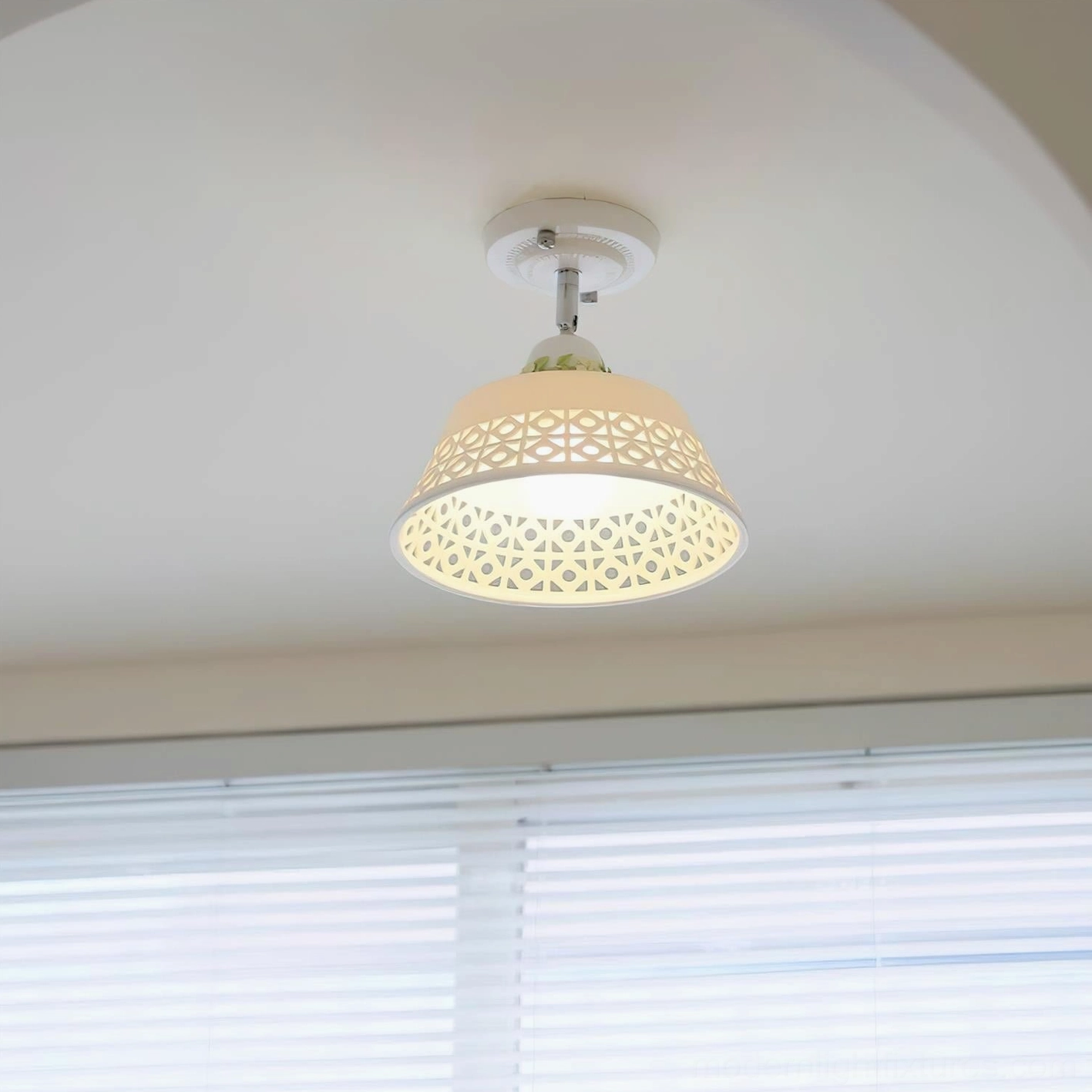 Modern ceiling lamp with artistic cutout pattern creating decorative shadow play and soft illumination