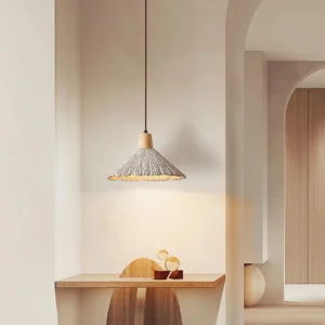 Cement pendant light installed in minimalist dining nook, warm bohemian interior design