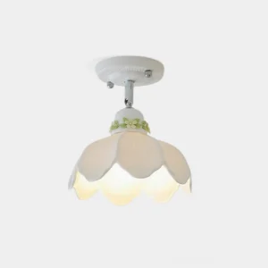 Modern ceramic ceiling lamp with floral cutout pattern and scalloped shade design, front view studio shot