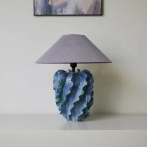 Modern ceramic blue table lamp with hand-sculpted textured base and soft grey conical shade, full product display
