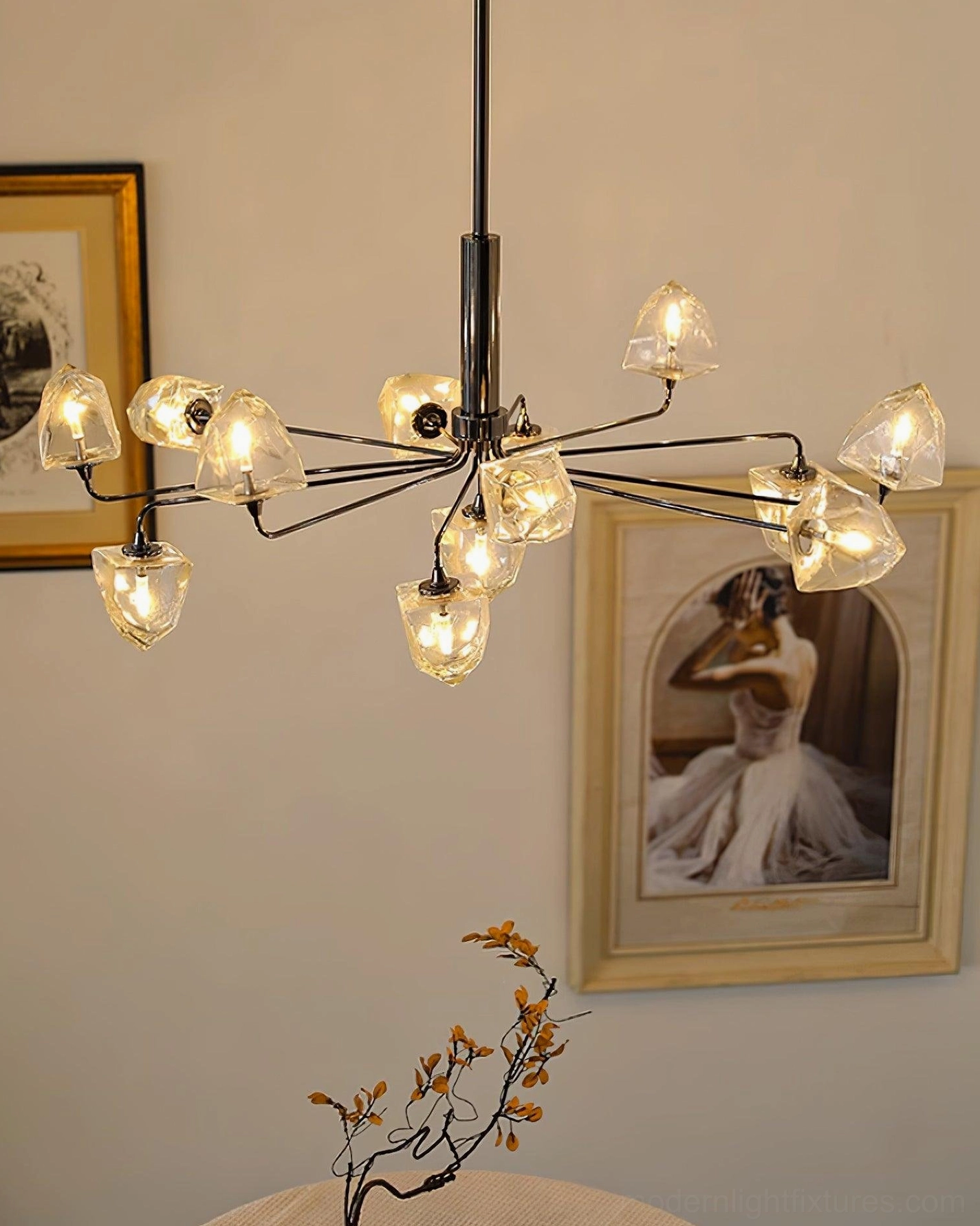 Modern glass chandelier close-up showing faceted clear shade refraction and brass gold metalwork
