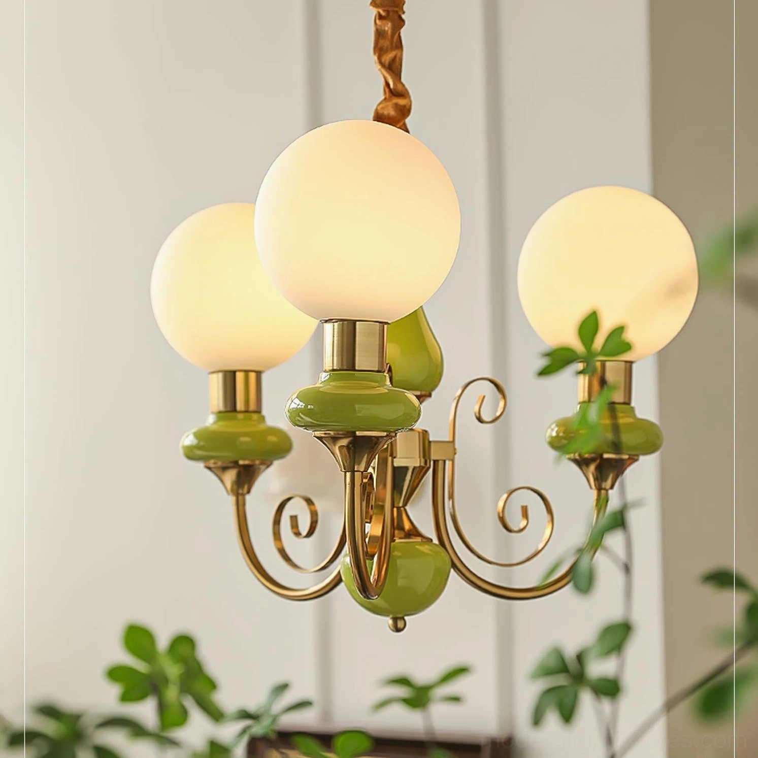 Modern glass chandelier fixture detail showing spherical frosted shades and metallic arms