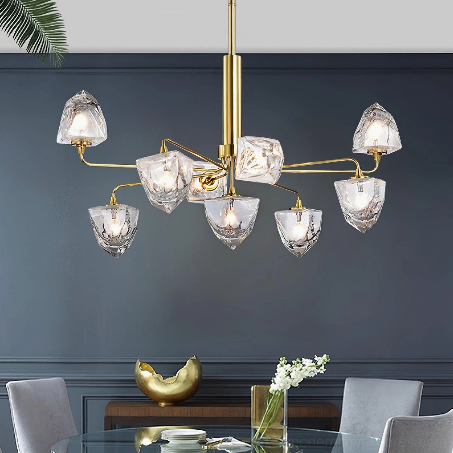 Modern chandelier installation detail showing glass shades connection and metal branching structure