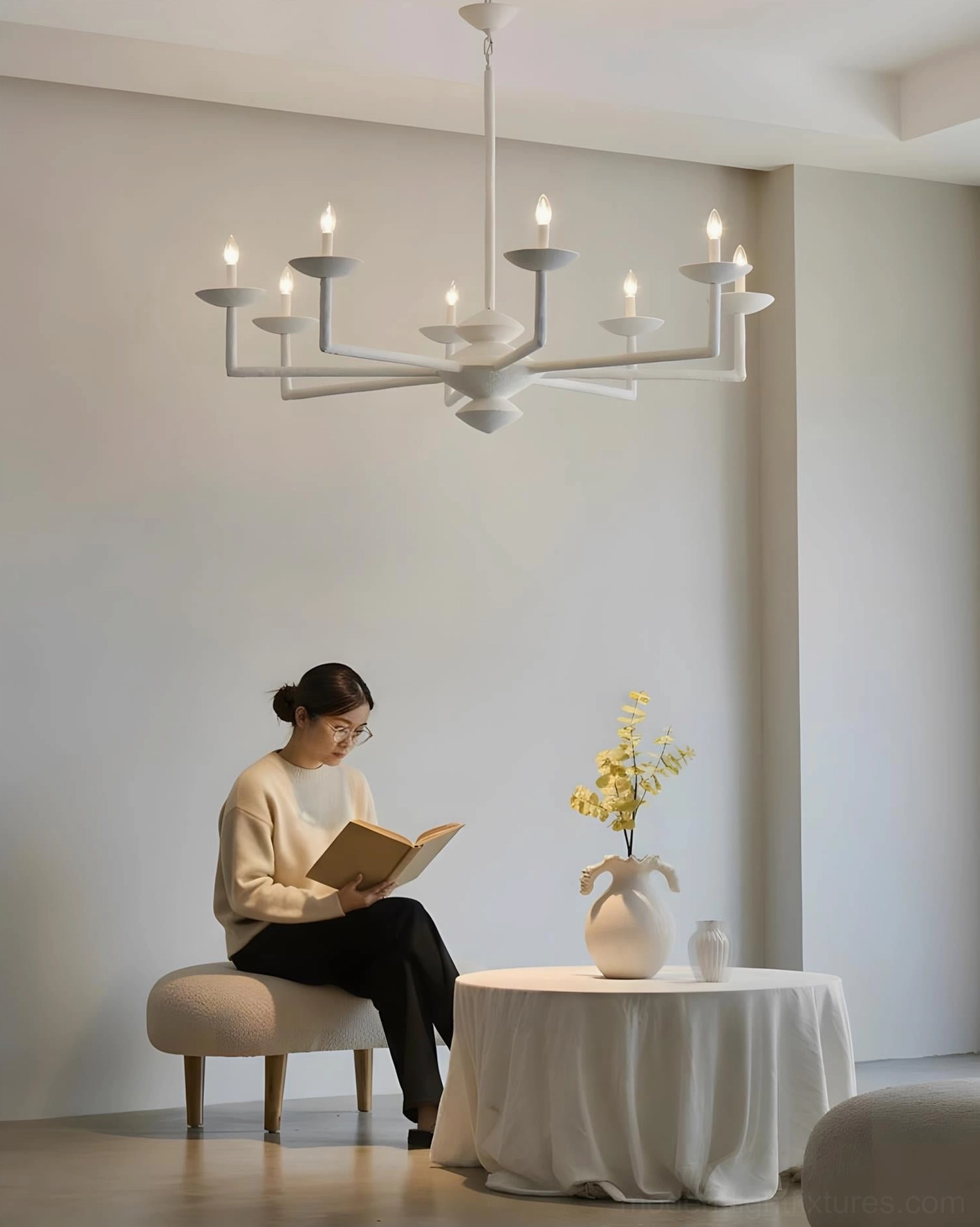 White multi-arm pendant chandelier installed in minimalist residential lounge, low-angle interior photography