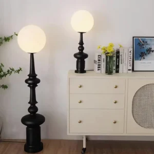 Pair of matching modern chess floor lamps in living room beside white storage cabinet and contemporary decor