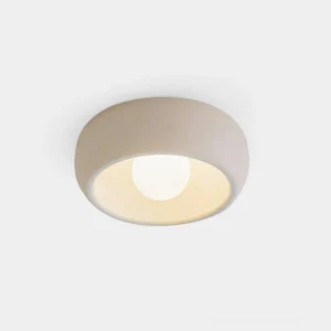 Modern circular flush mount ceiling light with carbon steel housing and frosted glass diffuser, front view studio product photography