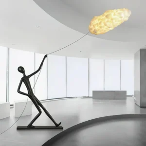Contemporary floor lamp with abstract black figure and glowing cloud-like light fixture, three-quarter front perspective