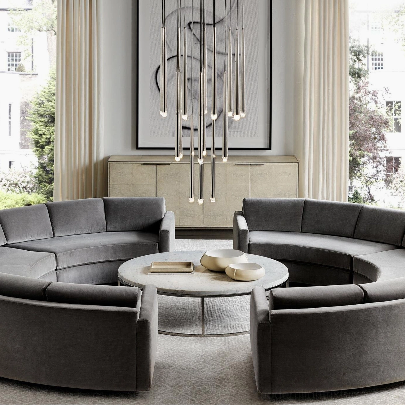 Minimalist brass suspended chandelier in contemporary living room with circular sofa