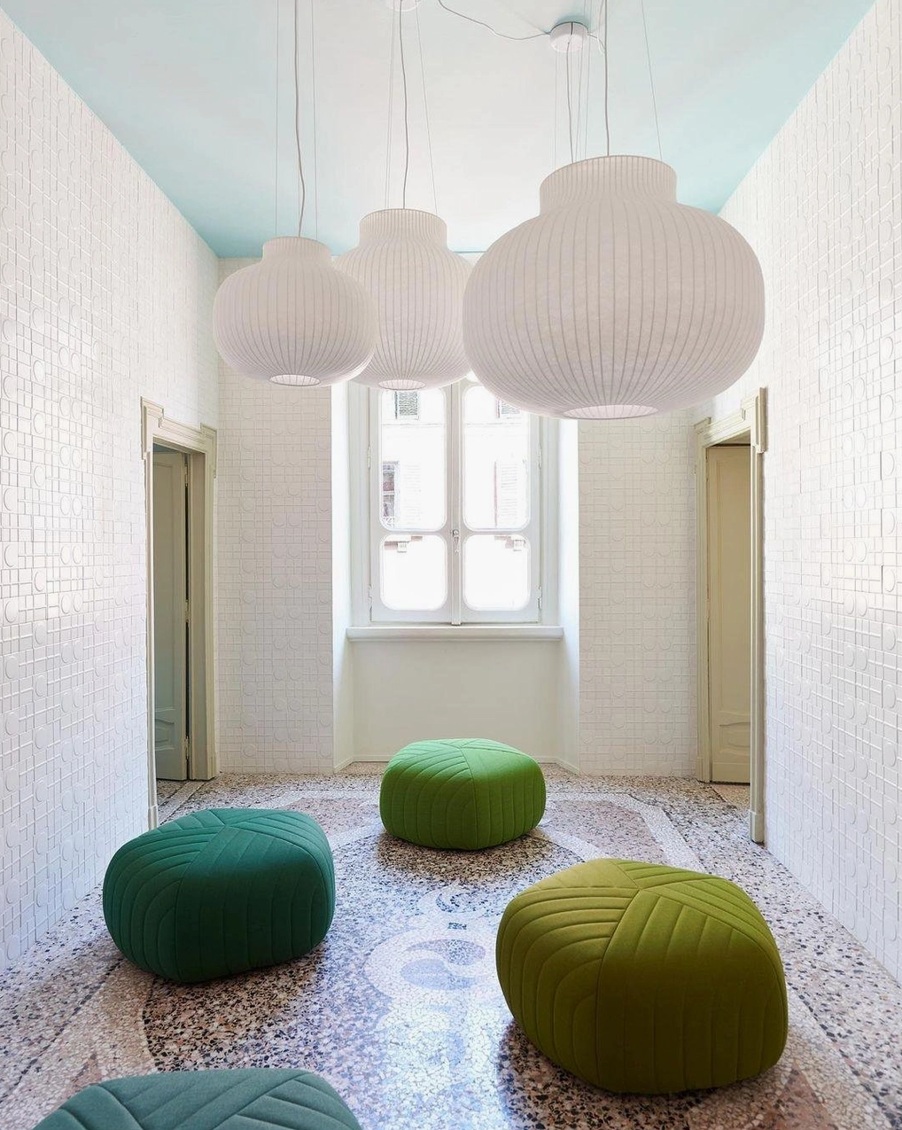 Modern white cocoon pendant light hanging in minimalist interior design space