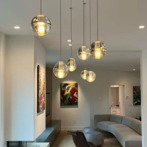 Contemporary crystal pendant light installed in modern luxury living room with warm ambient illumination