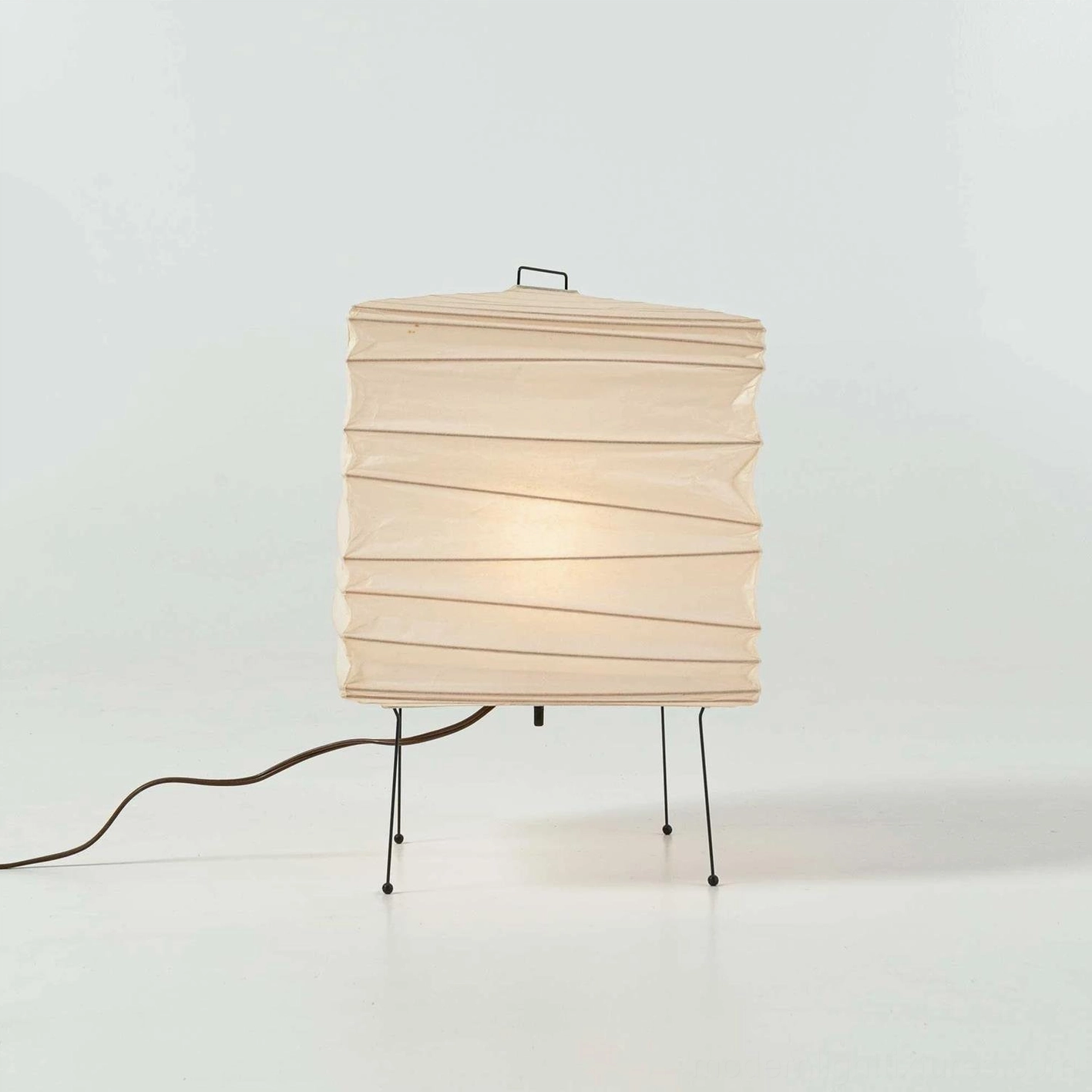 Modern geometric paper cube table lamp demonstrating soft diffused ambient light quality indoors