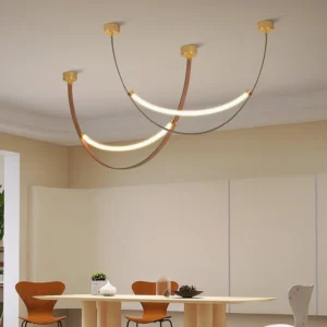 Dual arc pendant light installed above dining table in modern dining room with warm LED illumination and leather accent