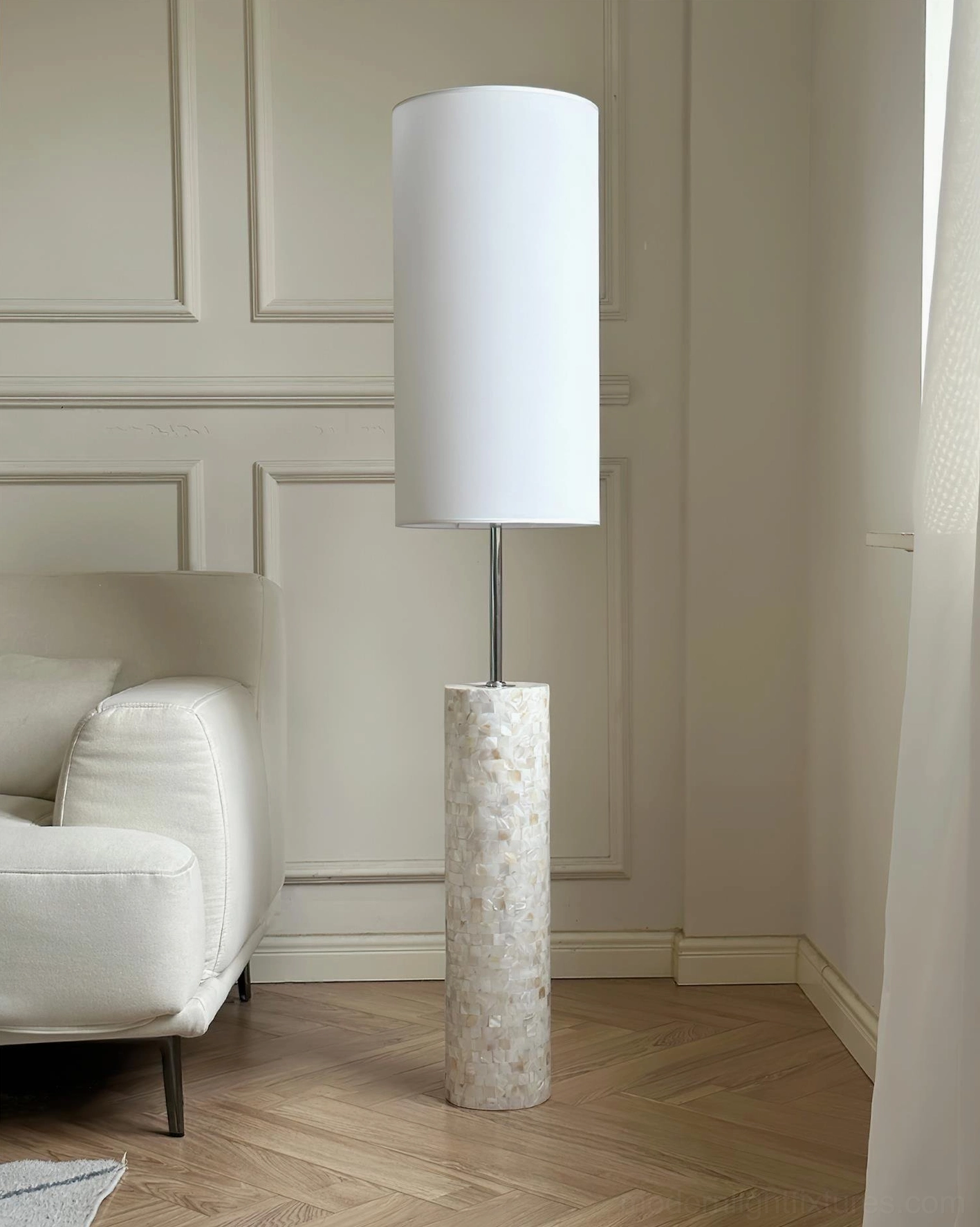 Contemporary minimalist floor lamp beside white sofa in modern living room with simple wall decor