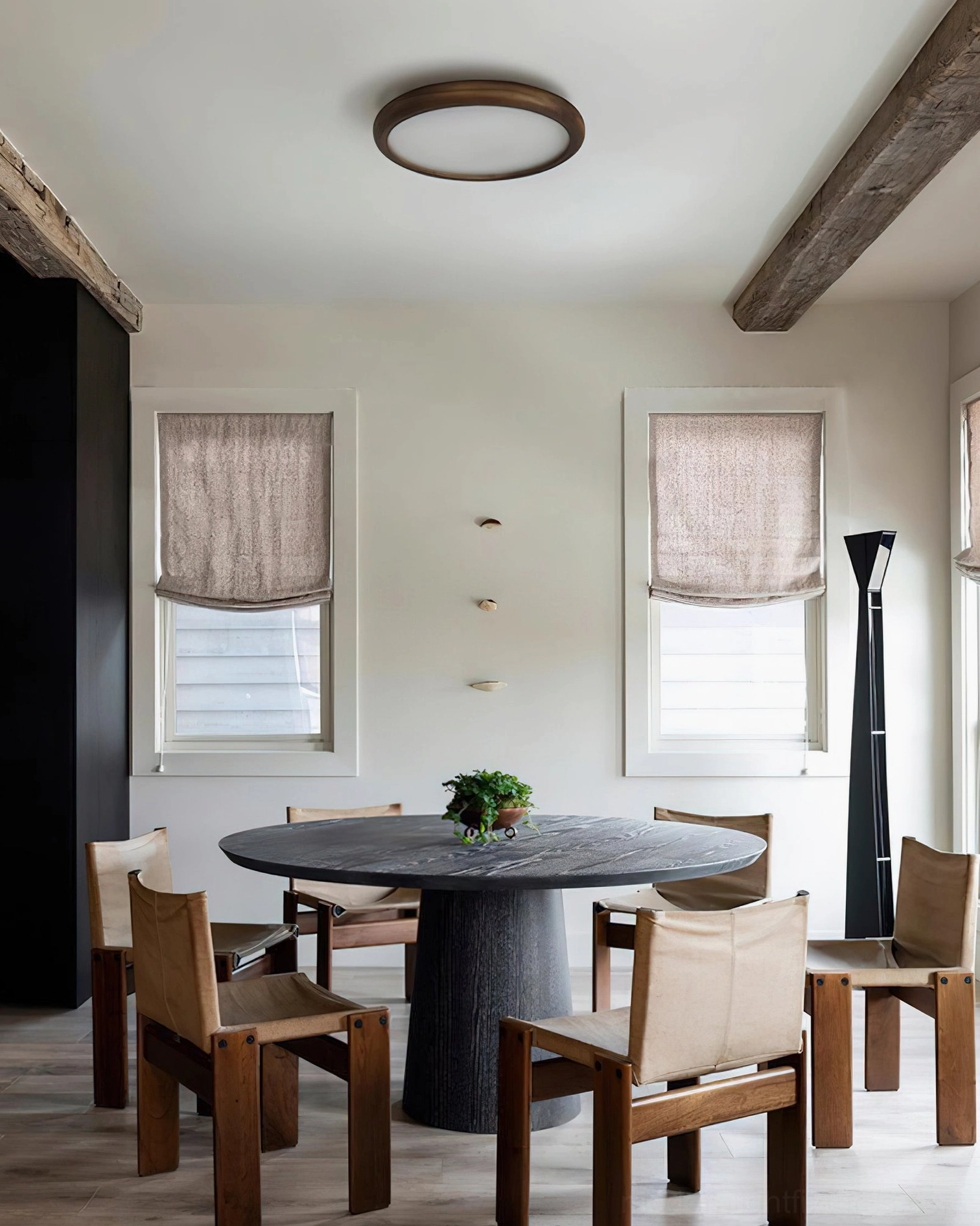 Contemporary ceiling fixture with dark wood frame illuminated in modern dining room, panoramic interior view