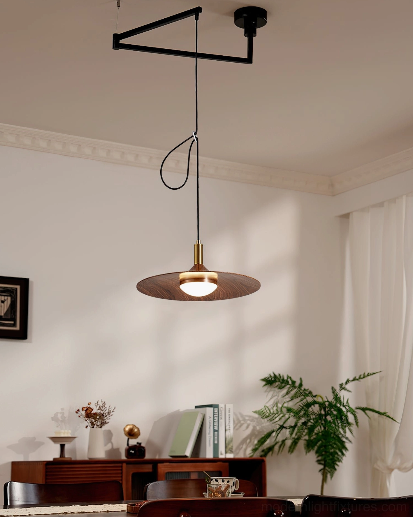 Mid-century modern disc pendant light hanging in residential living space with dining area