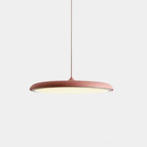 Dusty pink matte disc pendant light with adjustable cord on white background