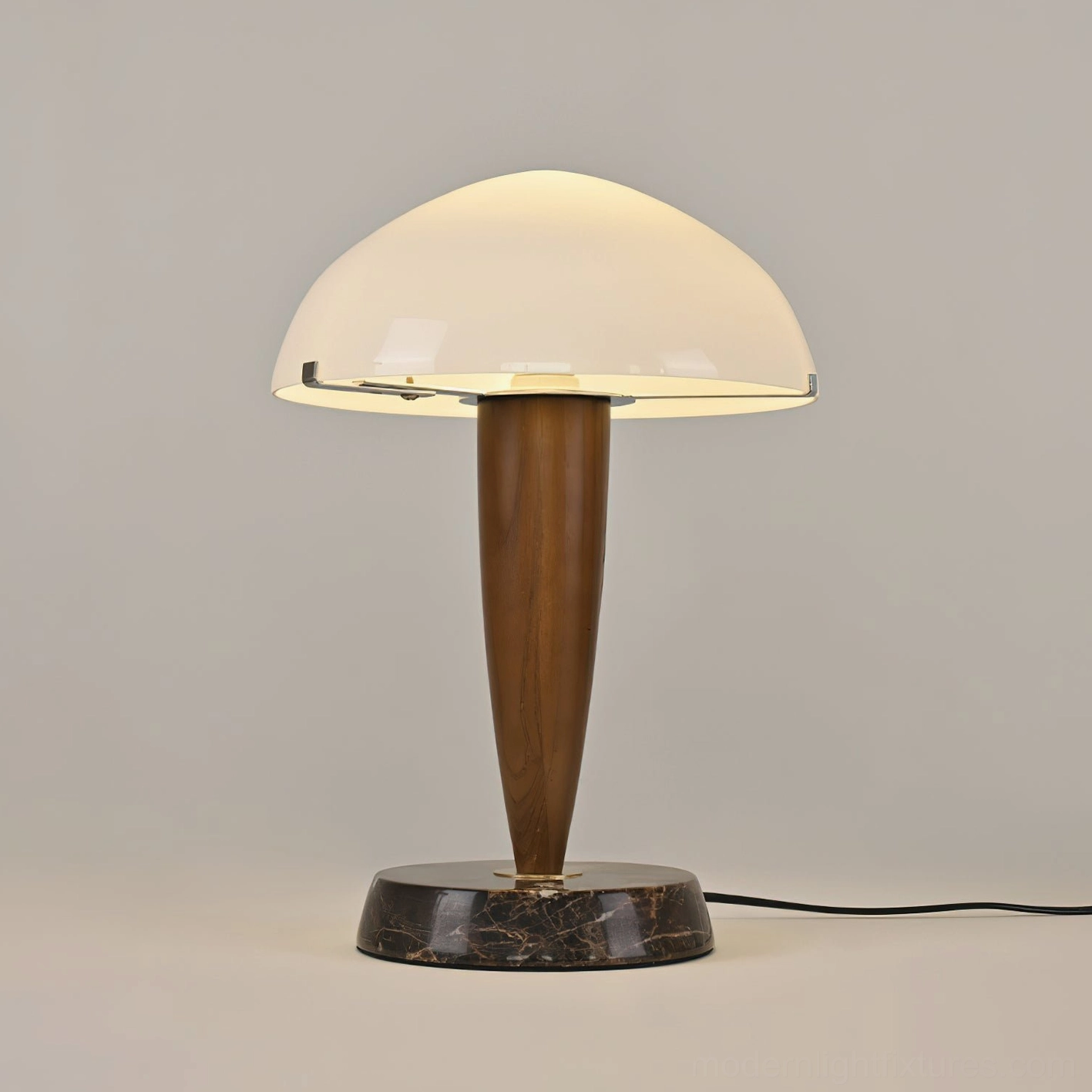 Contemporary marble base table lamp featuring walnut wood stem and dome shade with visible power cord on light gray backdrop