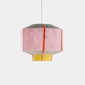 Colorful geometric faceted pendant light with pink, yellow and grey cotton thread shade on white background