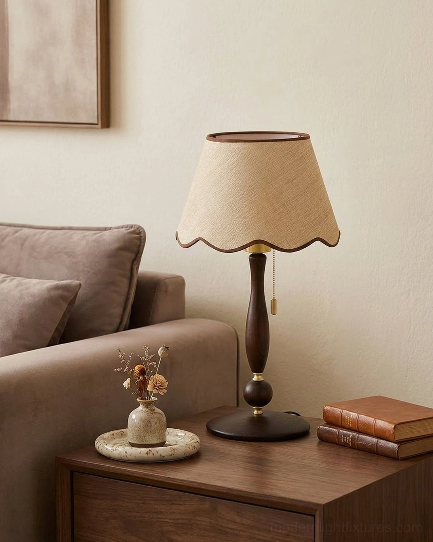 Modern farmhouse style scalloped table lamp on wooden side table with stacked books, dried flowers and natural home decor - side view