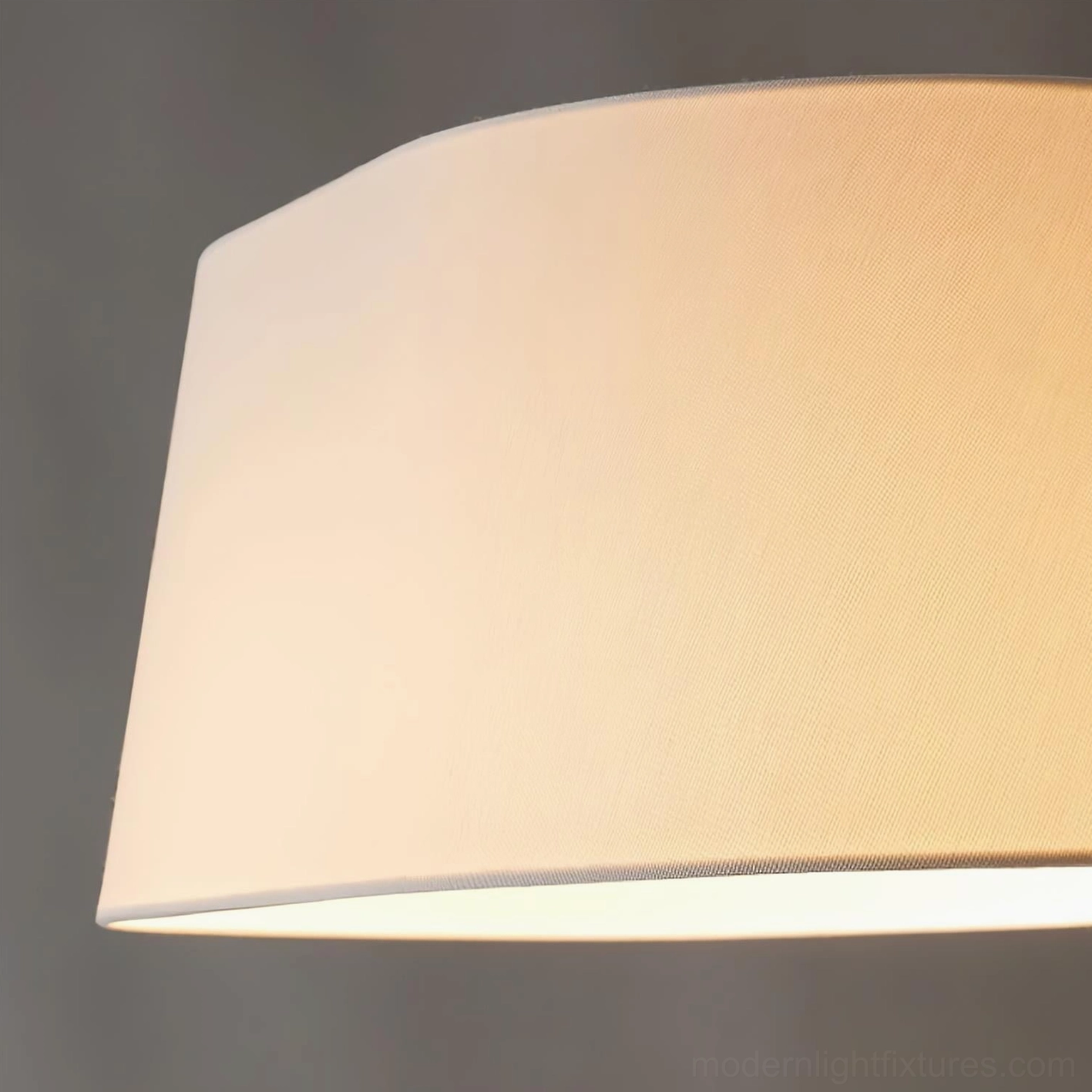 Modern floor lamp with angled metal frame and light-diffusing shade in interior design context