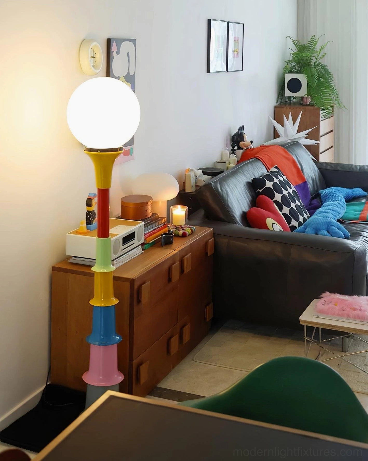 Colorful stacked floor lamp placed beside wooden side cabinet in American-style home living room