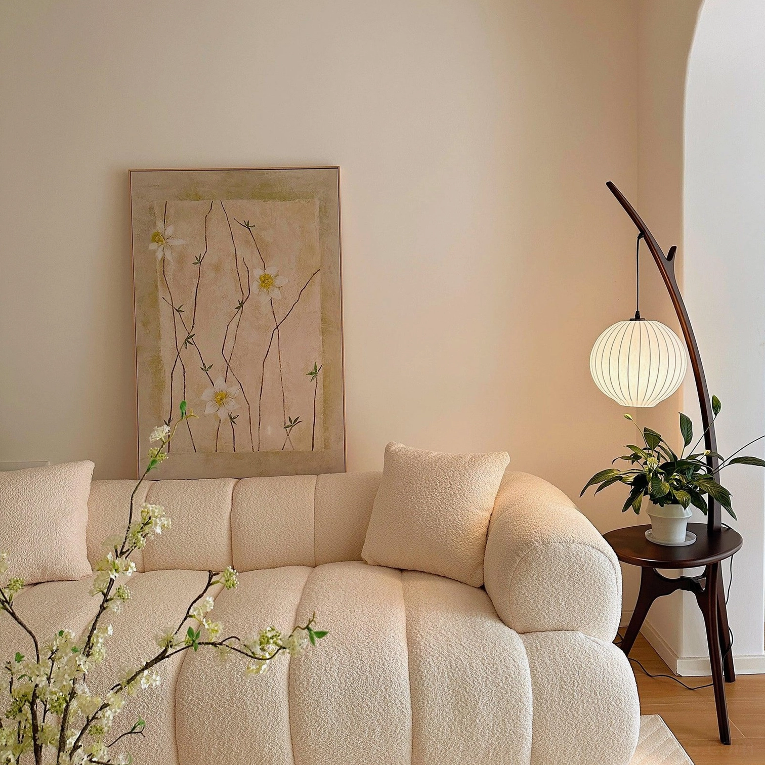 Modern floor lamp with side table and curved wooden pole in contemporary home setting