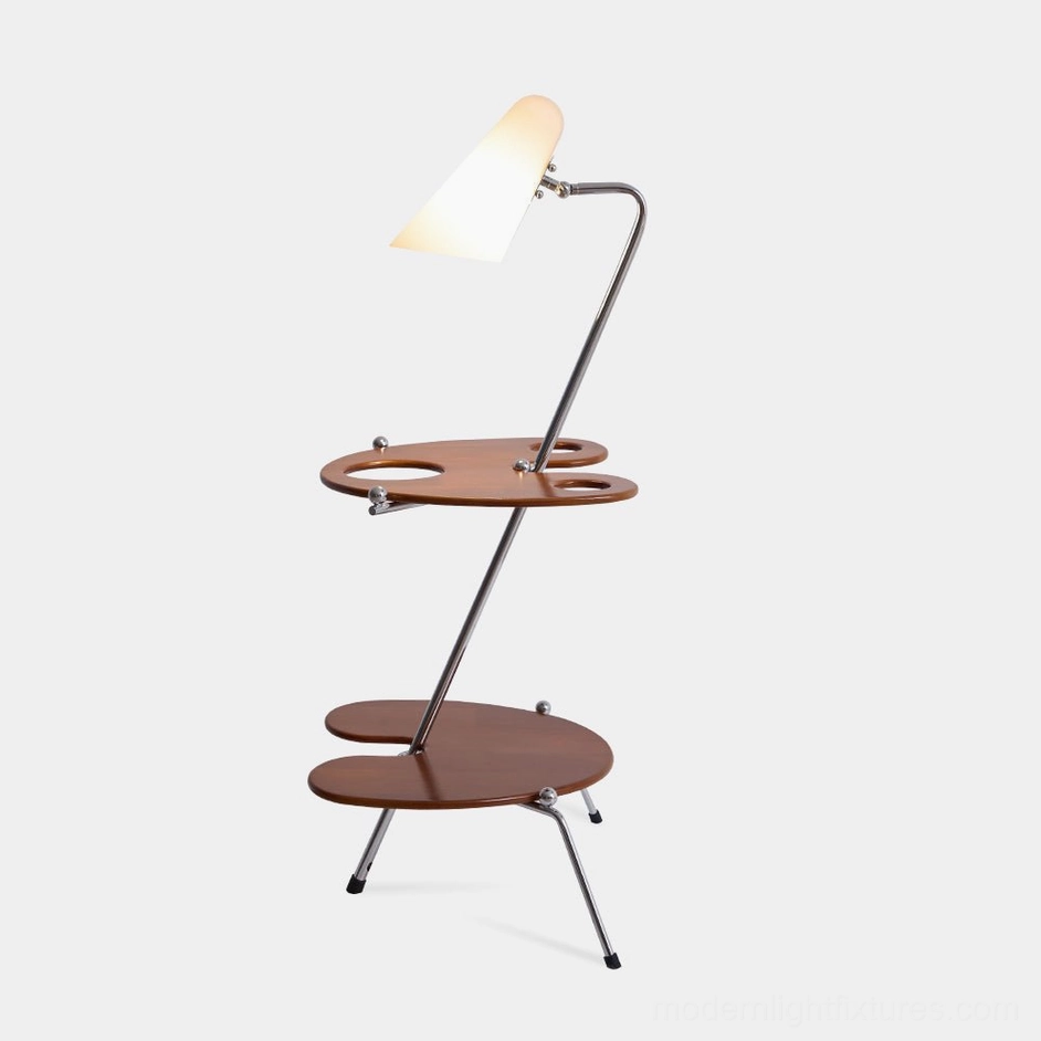Mid-century modern floor lamp with walnut wood shelves and adjustable opal shade, front oblique view in studio lighting