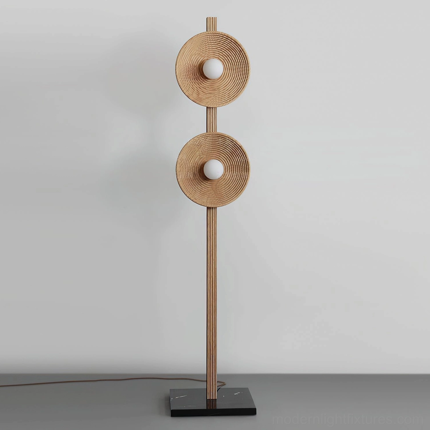 Sculptural twin disc floor lamp with fluted wooden pole and layered disc shades close-up detail shot