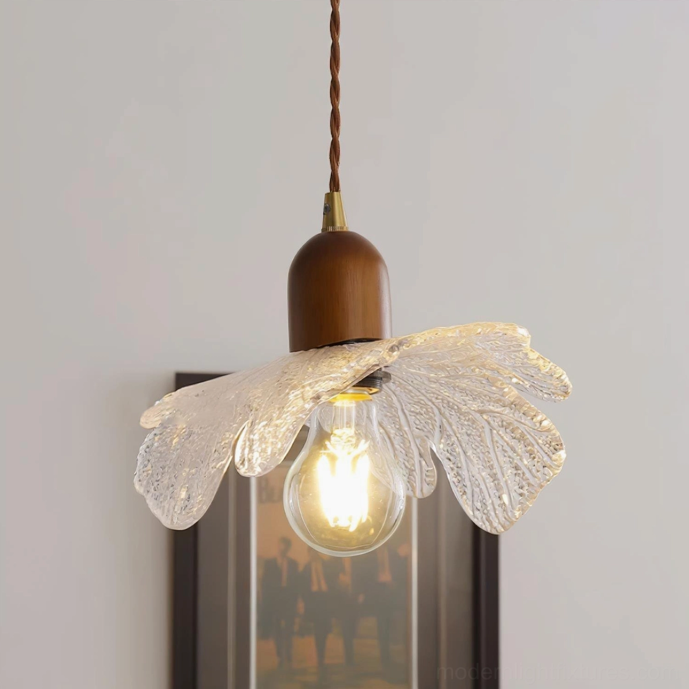 Modern floral ceiling fixture with petal-shaped glass and brass hardware in contemporary home