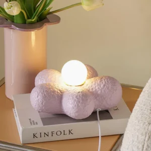 Purple flower table lamp styled on magazine in modern home office setting