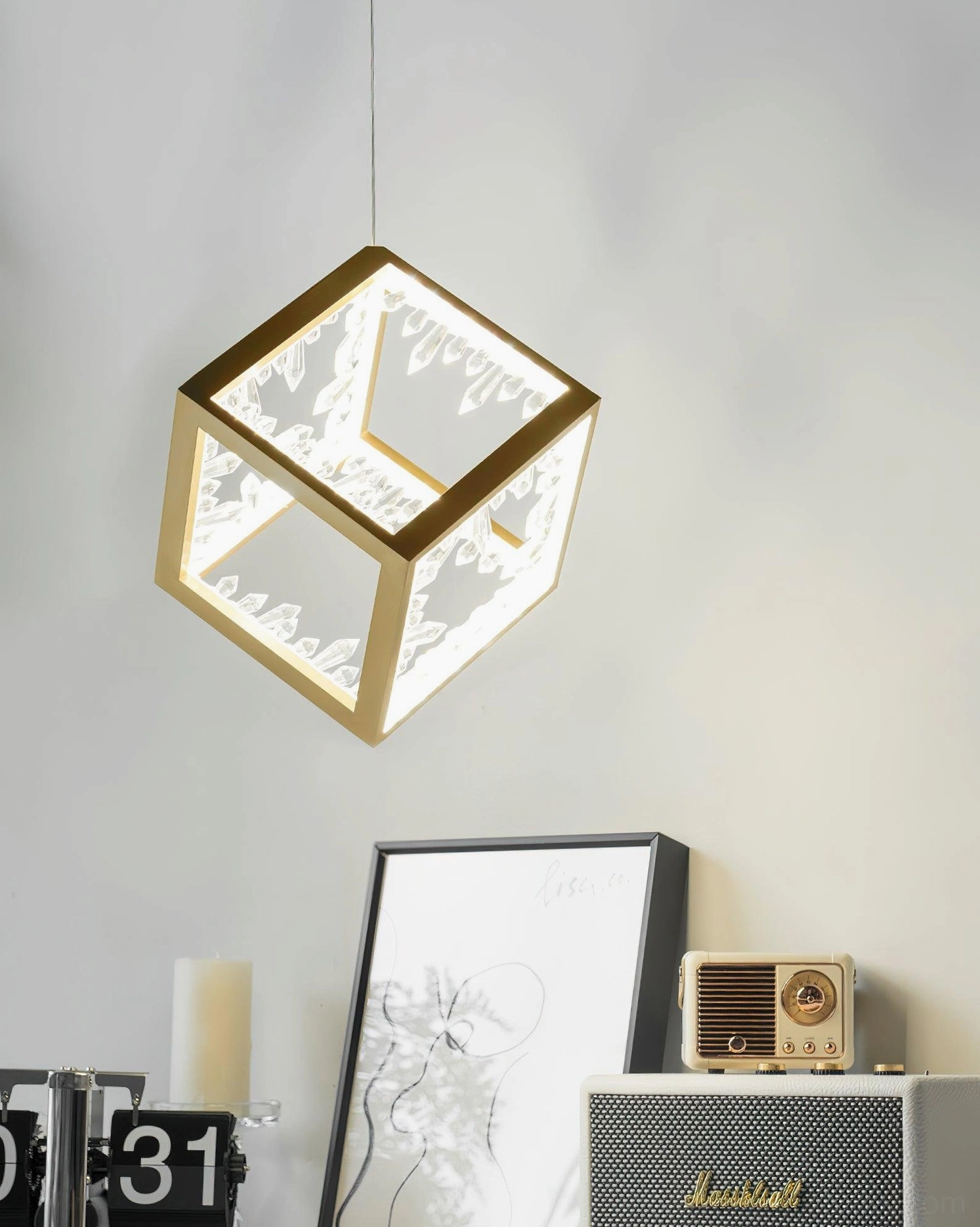 Modern gold cube pendant lamp with translucent crystal panels creating geometric light patterns