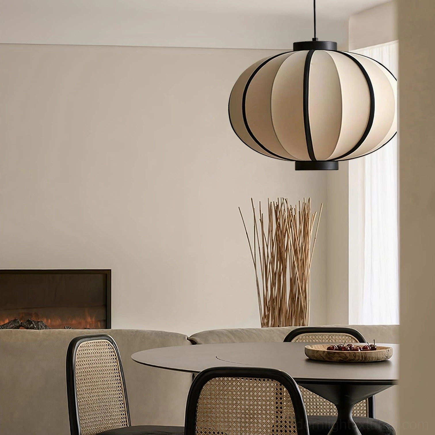 Contemporary black and white geometric pendant light above round dining table in minimalist home