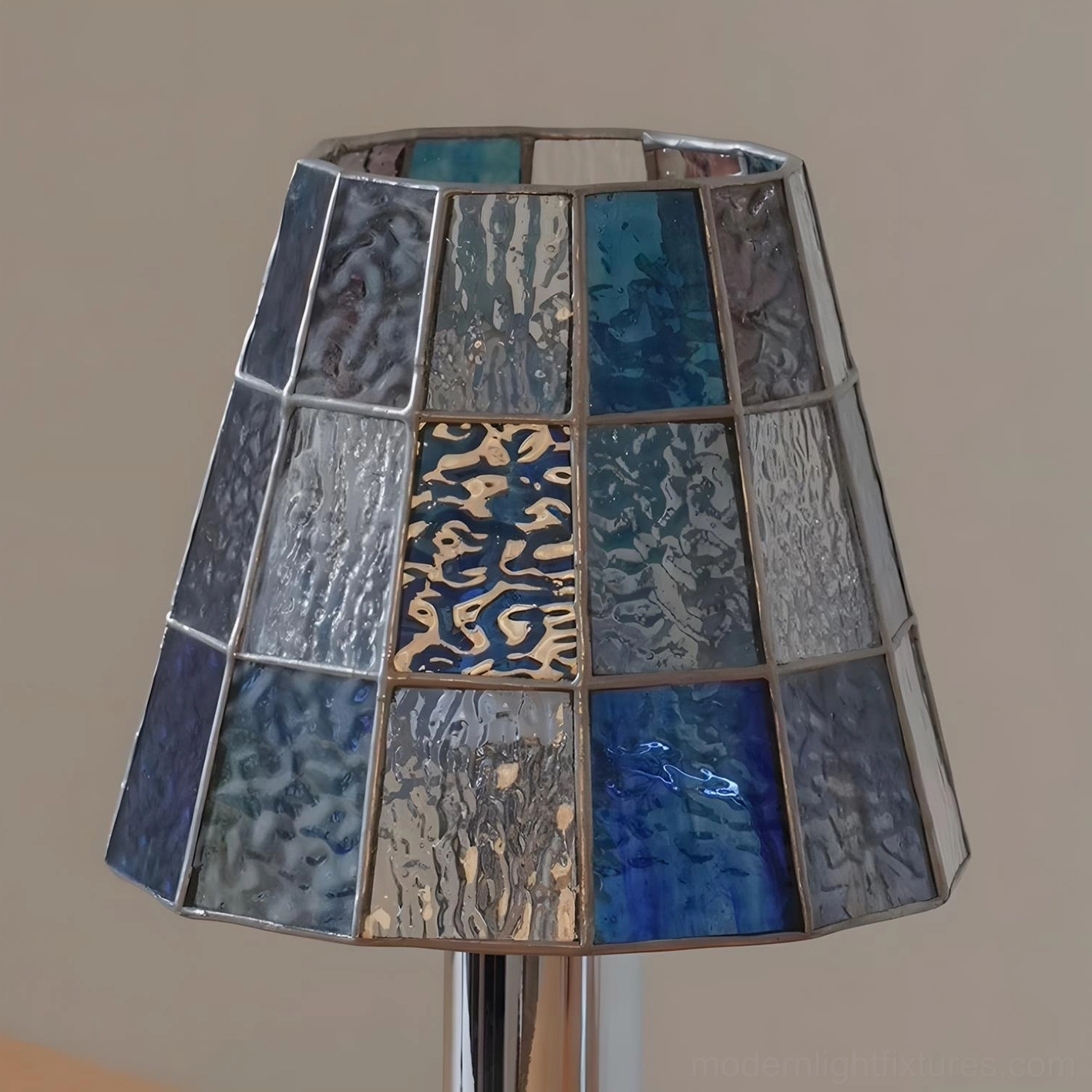 Modern geometric table lamp with stained glass shade on wooden surface showing full product design