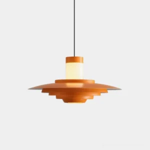 Geometric tiered pendant light with stacked metal discs in matte orange and frosted white finish, front view against neutral background