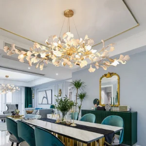 Long linear ginkgo chandelier installed above luxury dining table, overhead three-quarter view in high-end dining room setting
