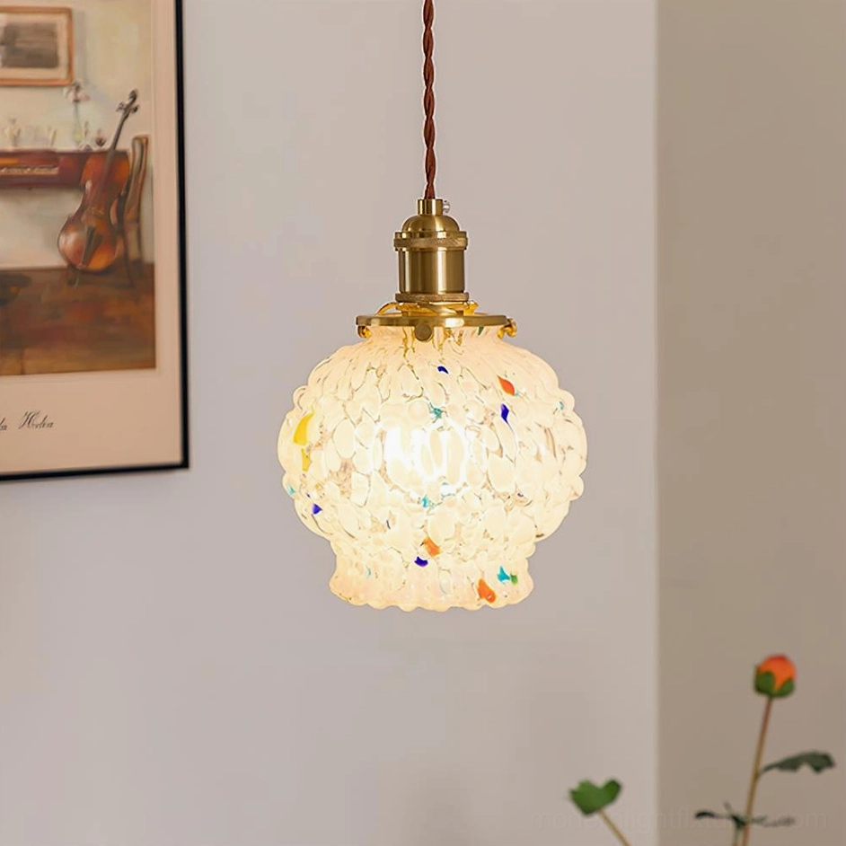 Lit hand-blown glass Kano Bubbles pendant lamp in vintage home interior, warm ambient lighting, brass fixture with twisted cord