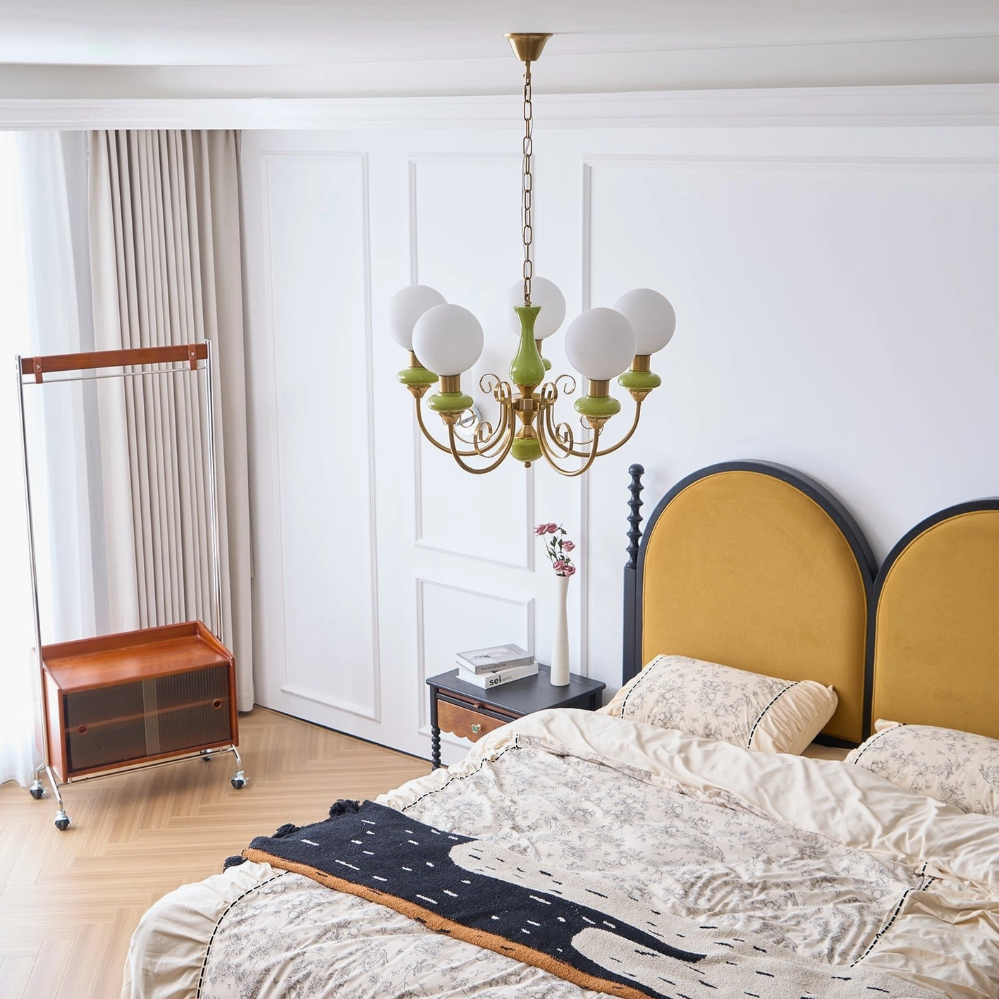 Modern glass chandelier with ceramic base accents, color-coordinated home lighting